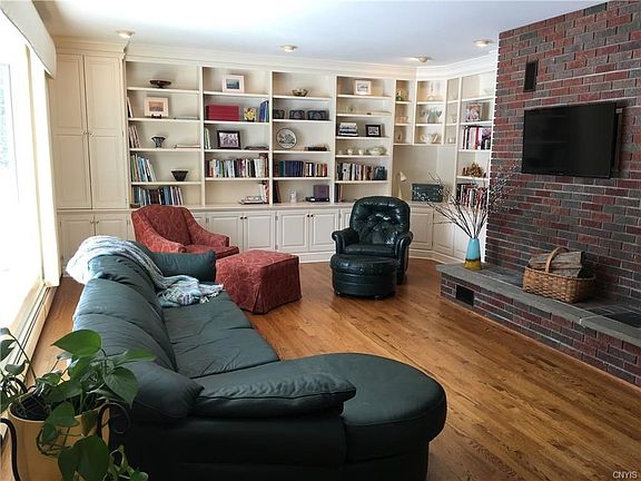Step inside this handsome Ranch and you enter the large living room with wall of built in shelves, bay window, and gas fireplace.