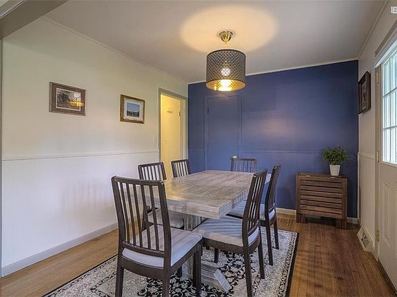 Dining room with super sheek lighting and accent wall. Door opens to patio.