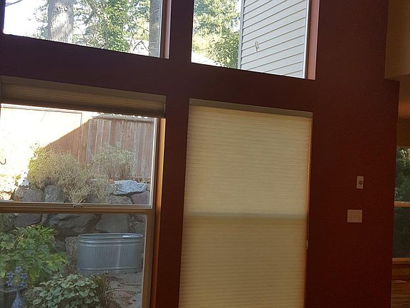 Floor to ceiling windows in the main living space, near the 