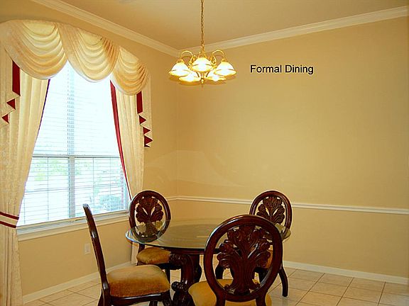 Chair rails and crown moldings in this entertaining Formal Dining.