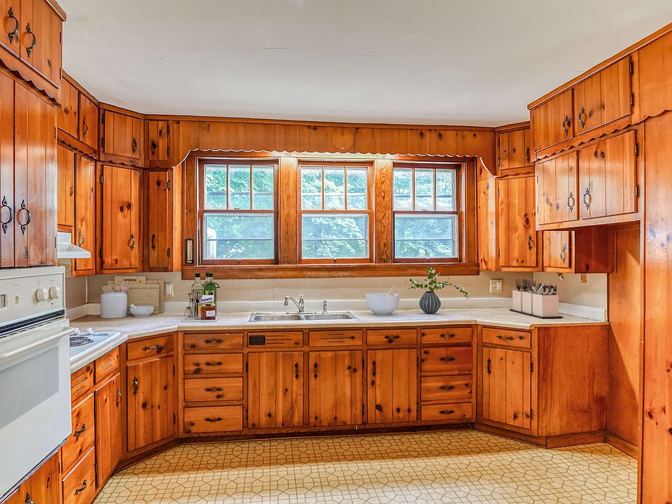 spacious kitchen large windows wood cabinets