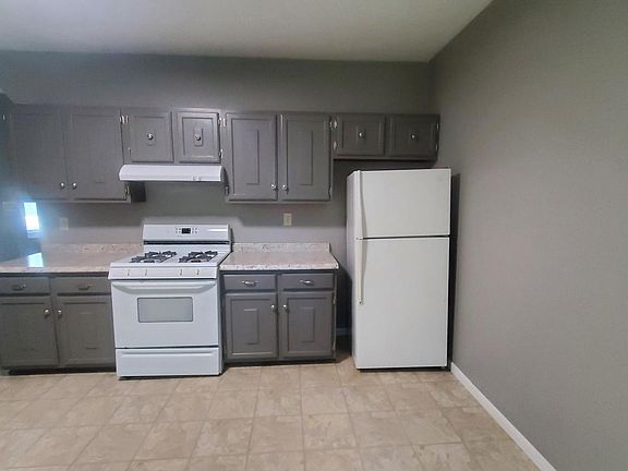 Kitchen with stove and refrigerator