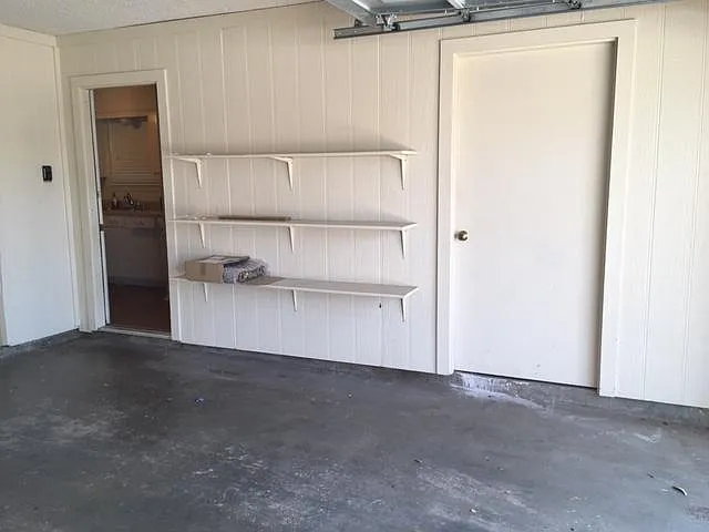 2 car garage with storage closet and shelves