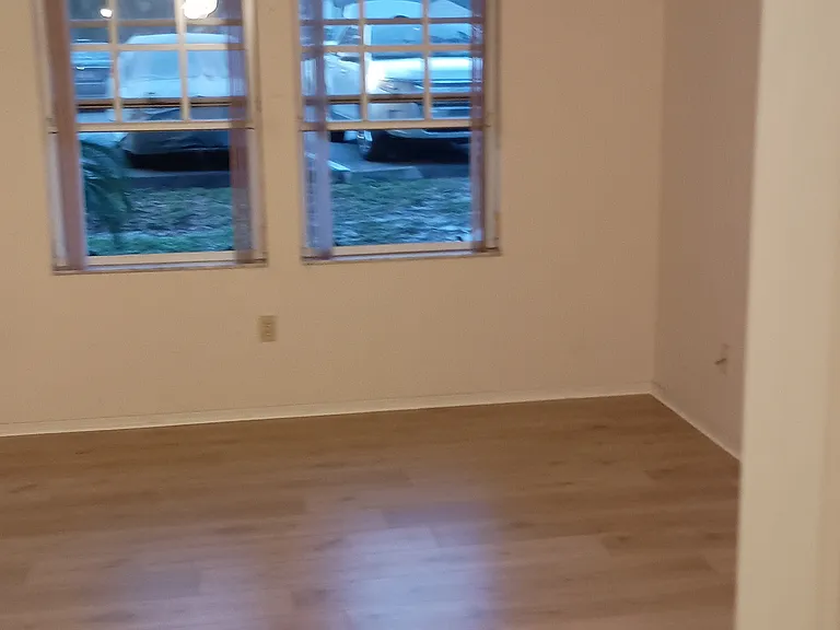 Right side of bedroom. There is also a door on the right wall leading into the living room. Unit has a circular flow design.