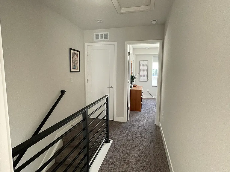 Third floor hallway looking into second bedroom