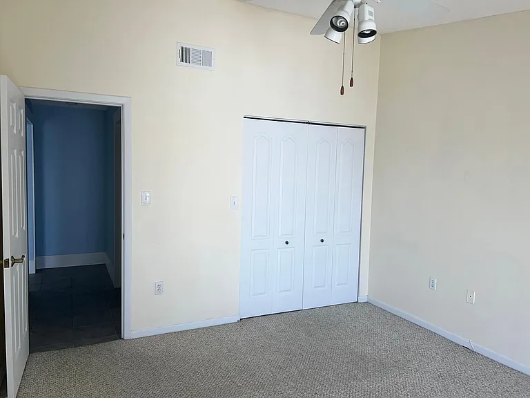 Secondary bedroom view of hallway and closet