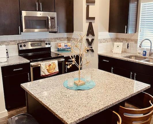 Kitchen and kitchen island with additional seating for two.