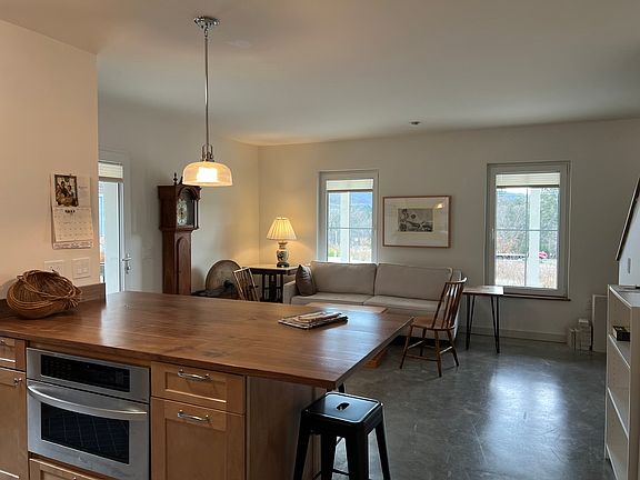 Open space living area, eat-in counter, and LG microwave/speed oven