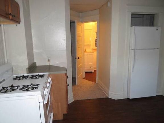 Kitchen looking into hallway to the bathroom and