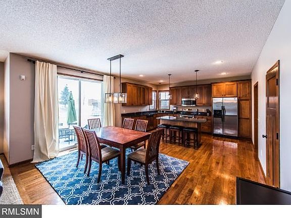 Kitchen area, hardwood flooring and walkout to stamped patio.