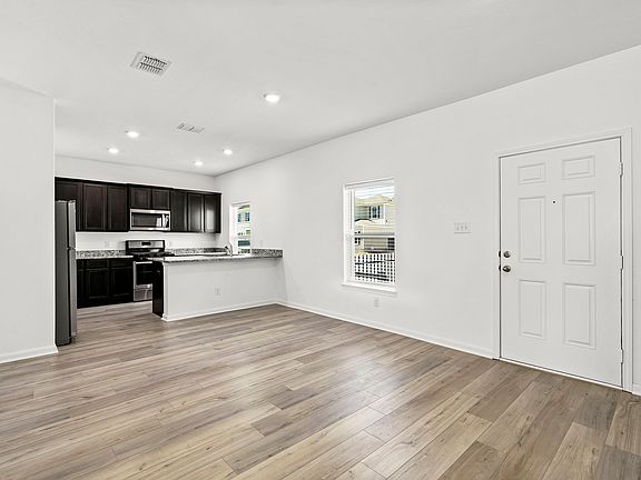 Open-concept layout with the upgraded kitchen overlooking the dining area.