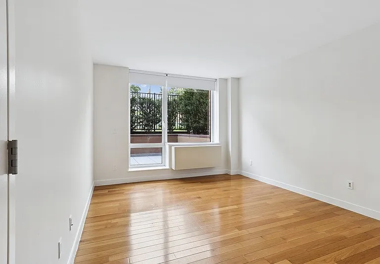 Step into the bright and airy interiors of Arbor. This spacious room features large windows that invite natural light, enhancing the warm wooden floors. Perfect for your personal touches. Schedule a tour today to see your future home!