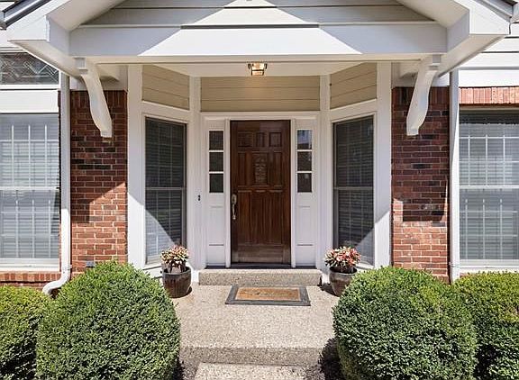 Grand Entrance w/ upgraded front door, aggregate sidewalk & front porch !!