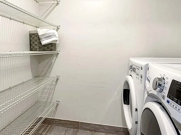 Griffis Pompano Beach apartment laundry room with washer and dryer.