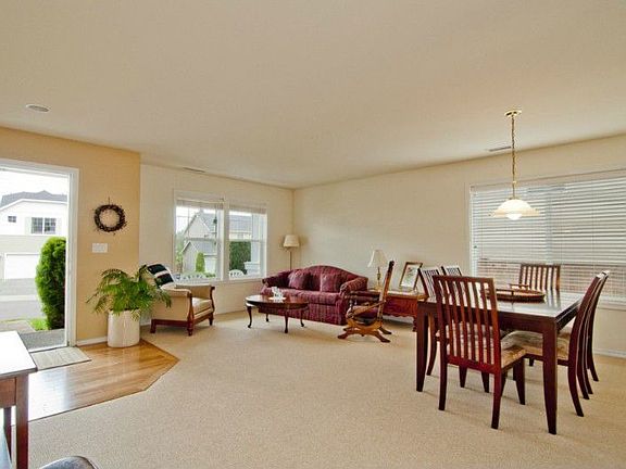 Hardwood floor entry and spotless carpet in the living room
