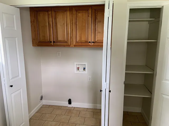 Overhead light in laundry room with extra cabinets