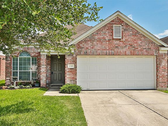 Inviting entryway with updated landscaping and freshly painted front door.