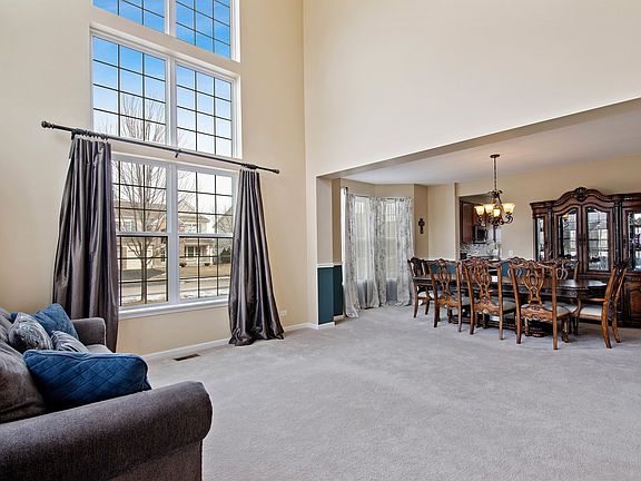 Soaring ceilings in the foyer & Living Room ~ Open to Dining Room w/ Bay Window & walkway to kitchen