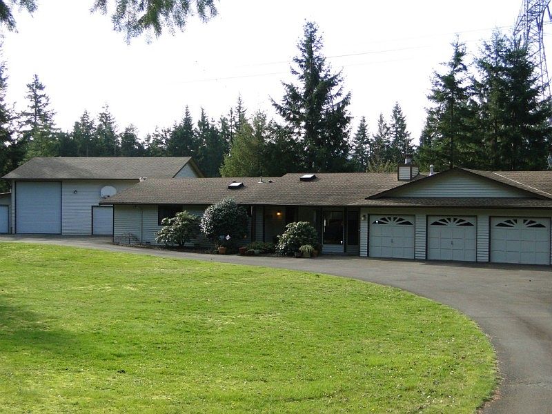 Sprawling ramber with circular drive, easy access to all covered parking.