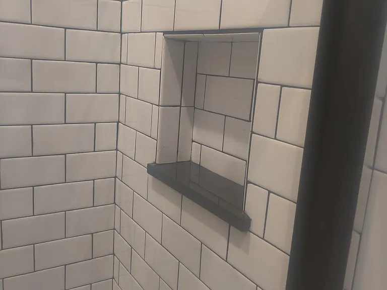 back ledge opposite showerhead