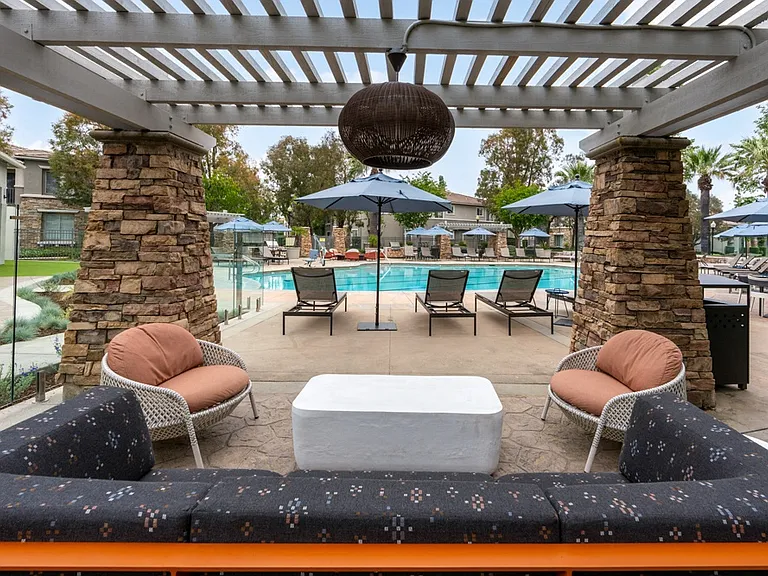 Shaded Poolside Lounge with Comfortable Seating and Pergola Cover