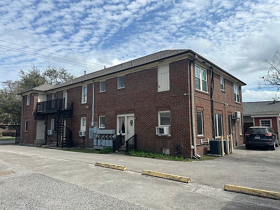 Driveway to parking lot with one space per apartment.