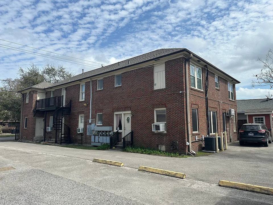 Driveway to parking lot with one space per apartment.