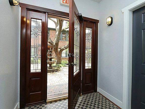 Leaded glass front door to the bldg. There is a common storage closet under the stairwell for use by
