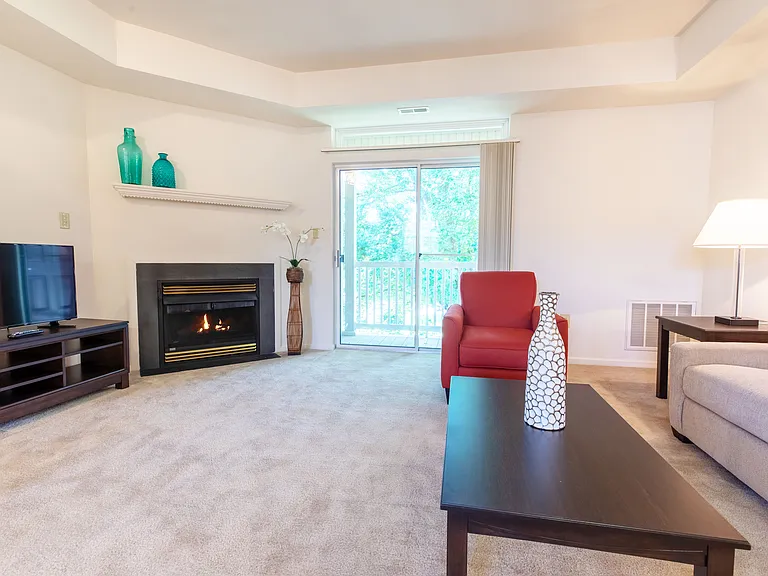 Living room with gas fireplace and sliding glass doors to balcony.