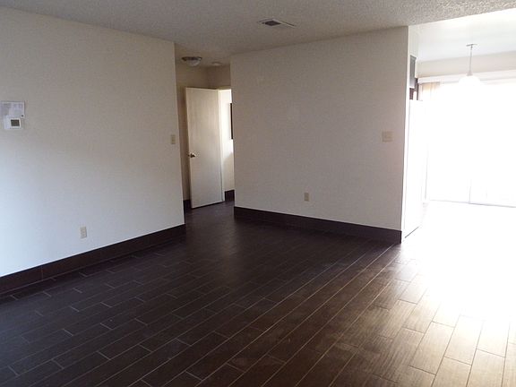 spacious living room, dining room with sliding door that leads into a private patio, door to a downstairs half bath and a coat closet with extra storage.