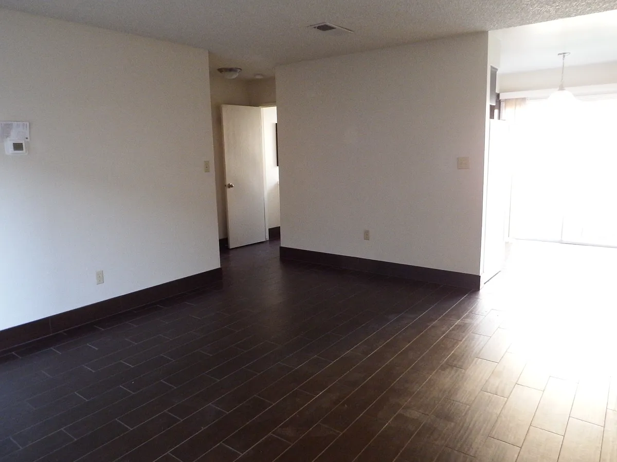 spacious living room, dining room with sliding door that leads into a private patio, door to a downstairs half bath and a coat closet with extra storage. - 111 Clifford Ave #5