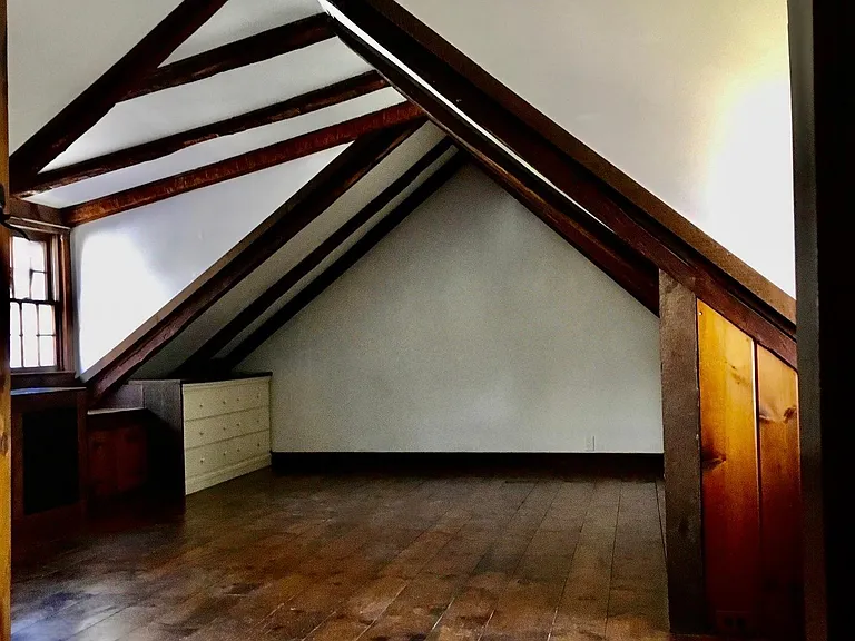 Master bedroom with original random plank floors, hand hewn beams, vaulted ceinlings, numerous built ins, with large his and hers closets