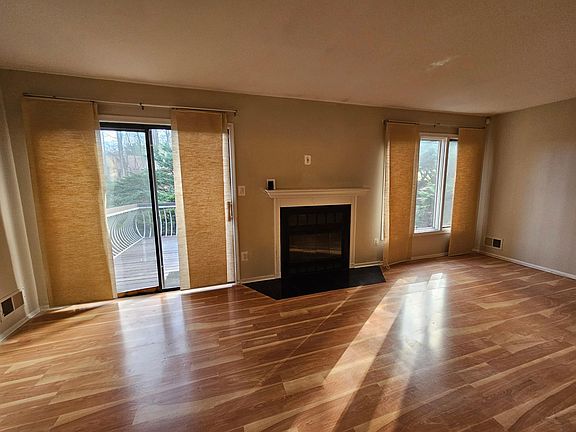 Living room with wood burning fireplace and sliders onto the deck