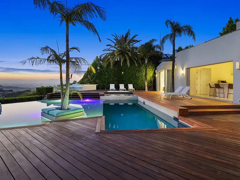 Delight in the Allure of the Pool at Night, with its shimmering waters reflecting the sunset.