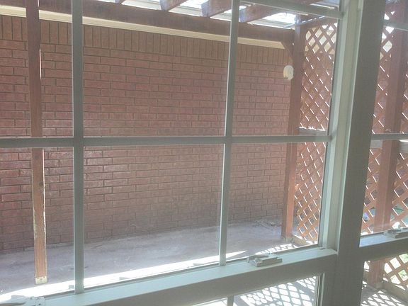Back yard patio. Window of sunroom looks out toward patio area