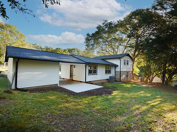Back patio area, attached garage and storage room.