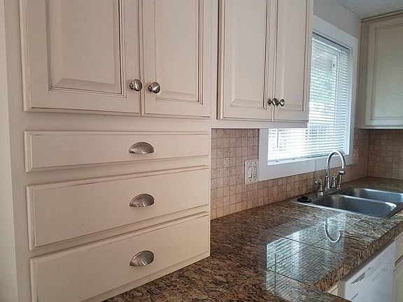 Antique glazed cabinets, granite counters, travertine backsp