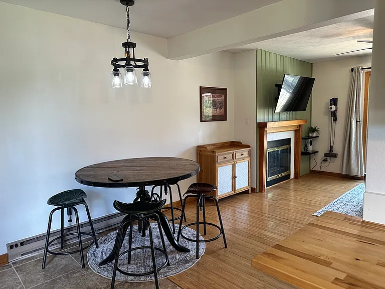 View of fireplace from kitchen