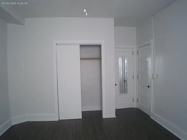 Master bedroom, ceiling fan, two closets. 2nd closet is a walk-in with lighting, multiple shelves and full-length mirror attached to closet door.