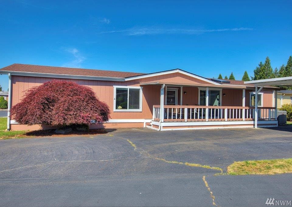 Nice corner lot with large covered front porch and new 2 car carport