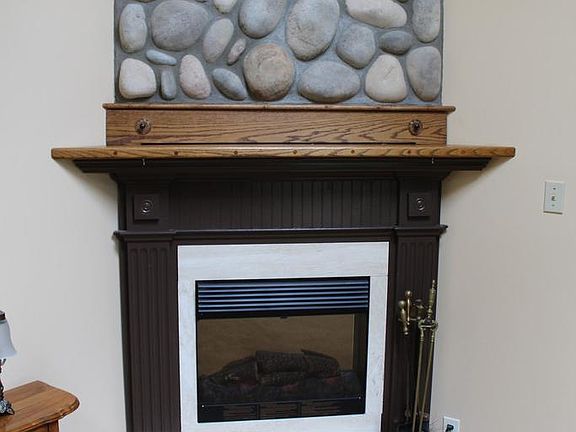 The electric fireplace anchors the corner of the room.