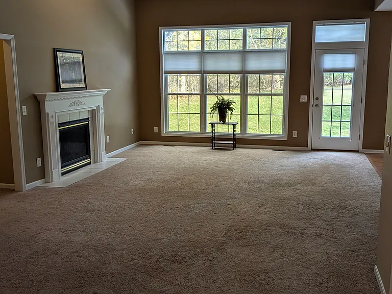 Living room area includes gas fireplace and exit to back patio