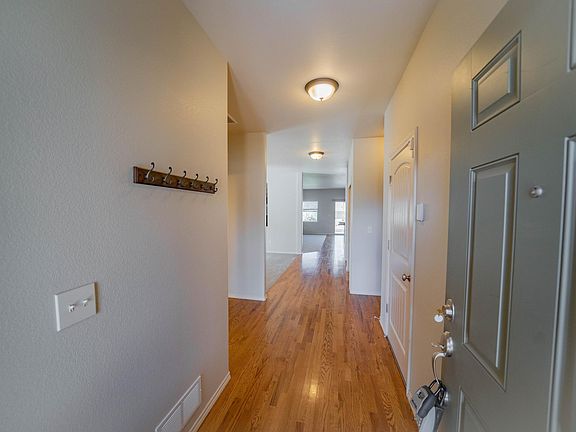 Still in front entryway, but turned around 180 degrees - first alcove to left is for that BR/BA with the garage door opposite - first door on right to garage - 2nd alcove on left (carpeted) is the dining room - we'll move forward to the very end which has