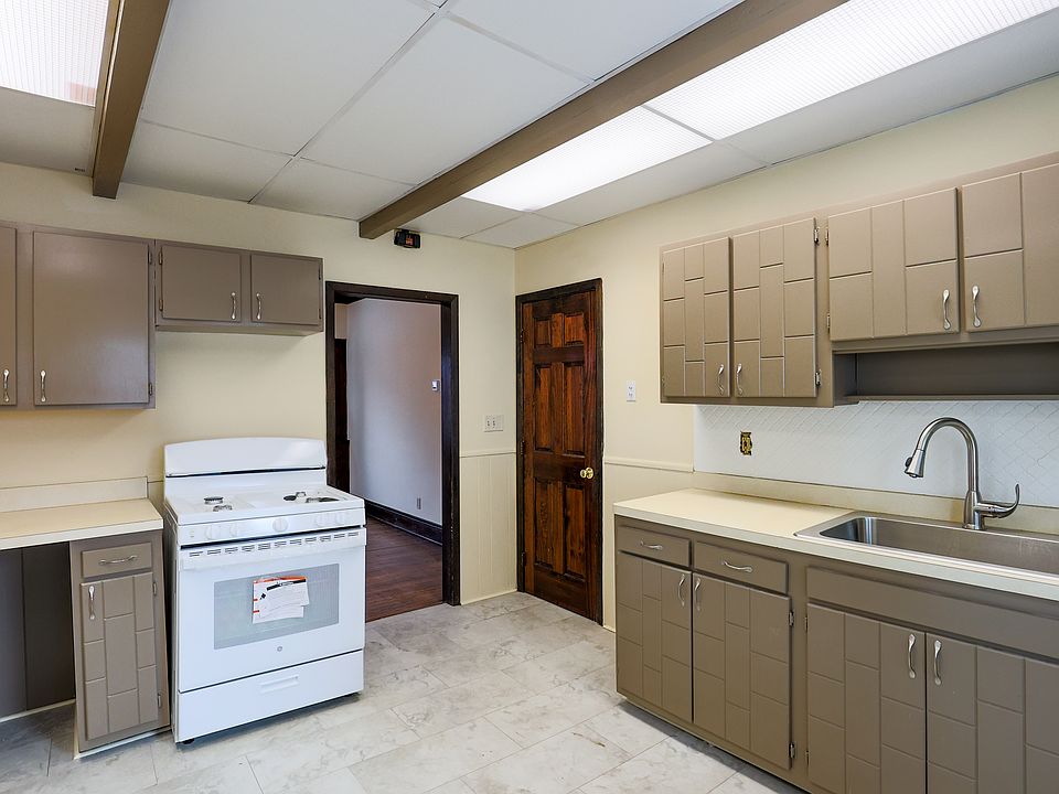 kitchen with new stove top and refrigerator