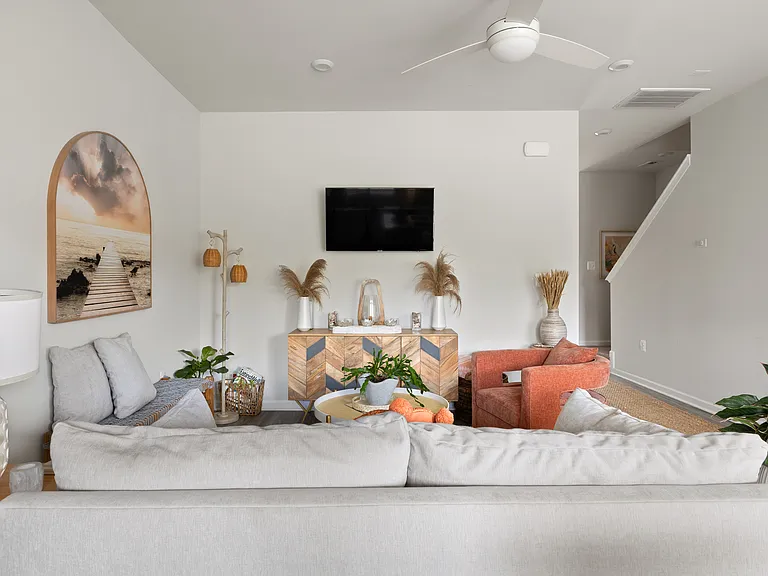 Living room with hallway to stairs