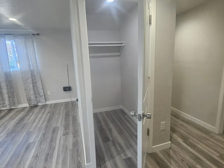 Main living area with hall closet that's extra spacious.