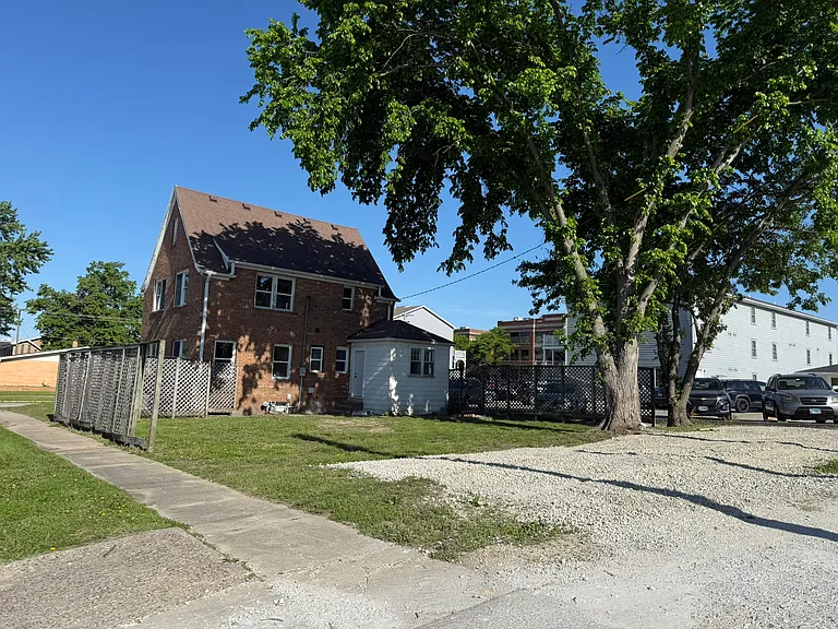 Gravel parking in the rear.
