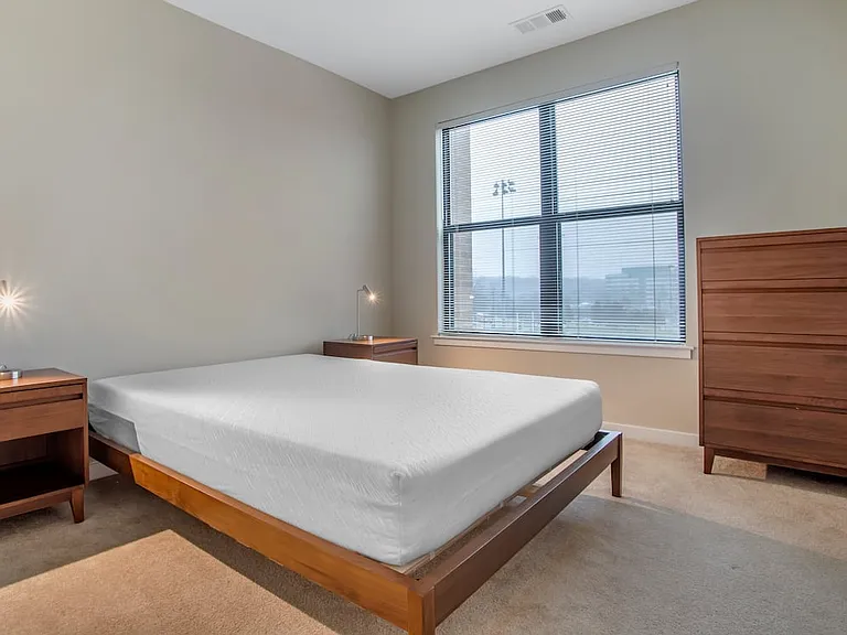 Furnished+ apartment homes feature queen bed with mattress, dresser, nightstands, and lamps (Representative Image exact items and style of furnishings may vary)