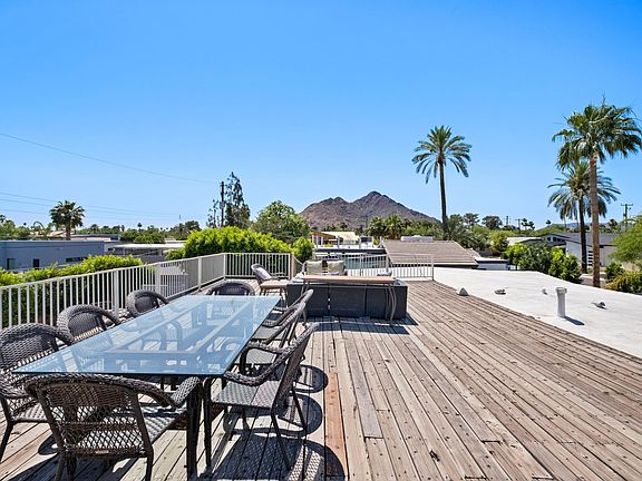 Dining table on roof deck west view of Camelback Mountain. Walk one mile to Cholla Trail.