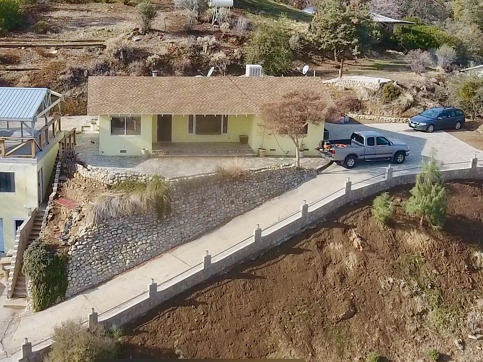 Garage, studio, covered deck on left, main house on right